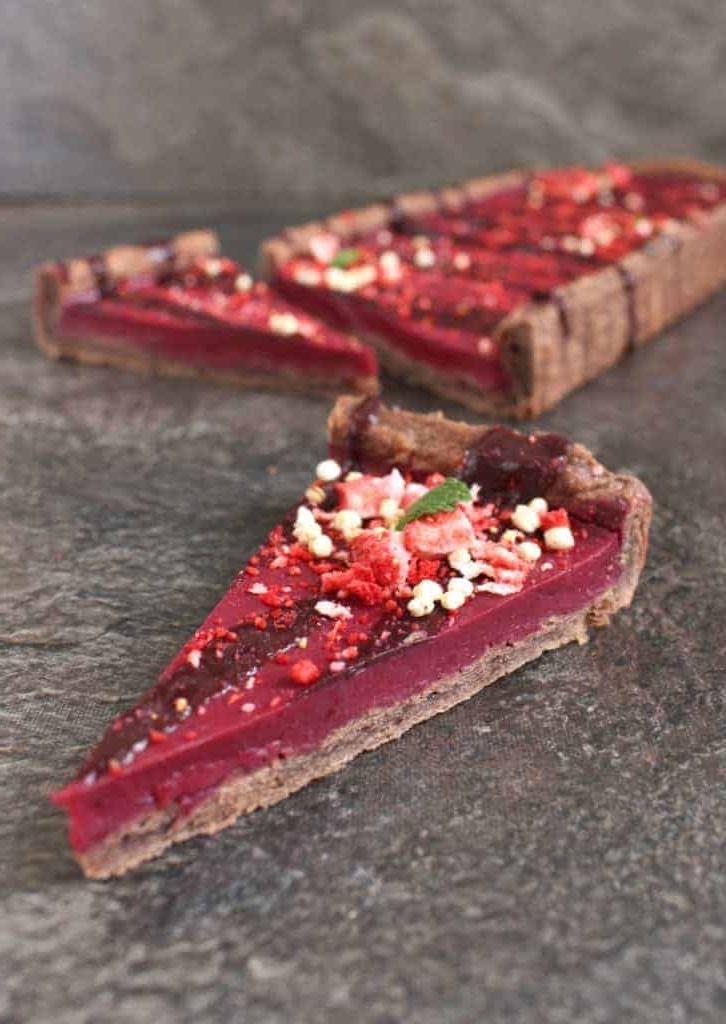 Close up on a slice of tart on a grey surface.