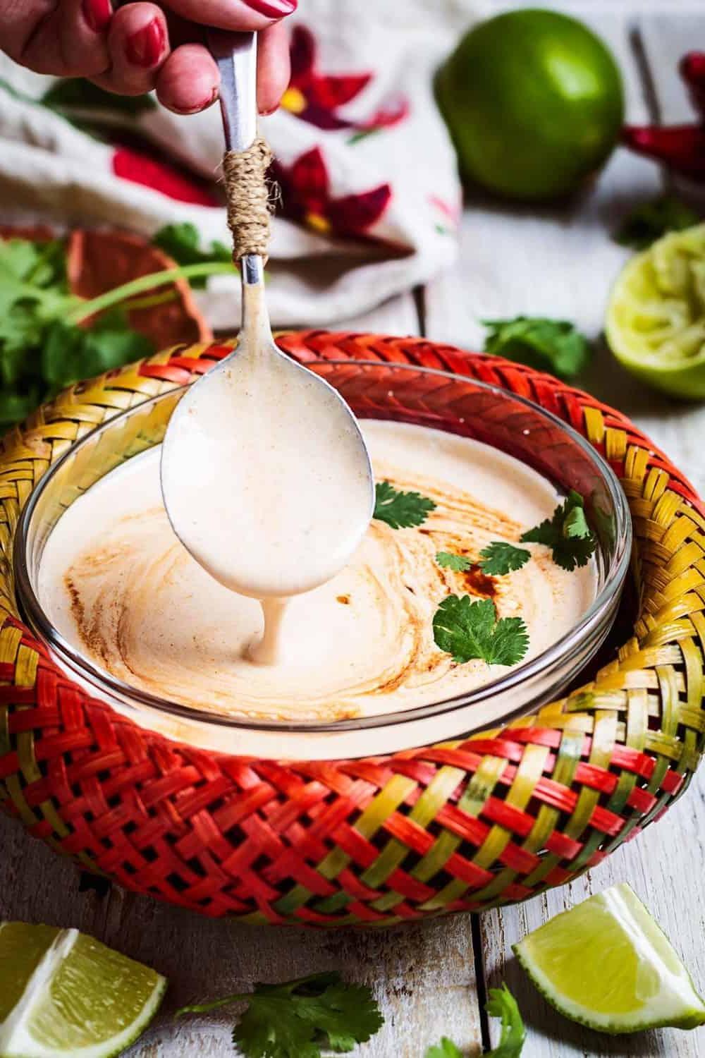 A close up of the sauce being scooped up with a spoon.