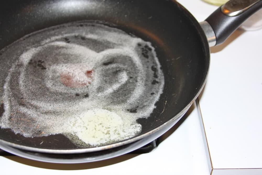 Green Beans Seasoned with Italian Dressing butter melting in a black frypan